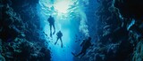 Fototapeta Fototapety do akwarium - Scuba divers exploring a vibrant coral reef under clear blue water