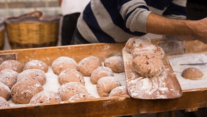 Wall Mural - Yeast dough in the form of loaves waiting to be cooked