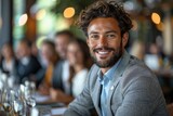 Fototapeta  - Handsome man with a beard smiling confidently at a social event, showing friendliness and charisma