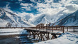 Snow-covered mountains with clouds. Old wooden bridge
