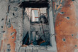empty window of a destroyed house in Ukraine