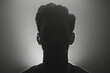 Dramatic silhouette of a man against a backlit background