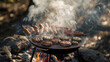 A rustic outdoor barbecue with smoke billowing from the grill, burgers and hot dogs sizzling over the flames.