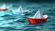 © photo for everything - A group of white paper ships in one direction and one red paper ship pointing in different ways on a blue background. Business for innovative solution concept.