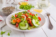Salad of fresh cucumbers, celery, sweet peppers, herbs and pumpkin seeds, sunflowers, sesame seeds with olive oil. Healthy vegetarian, vegan food. Italian Cuisine