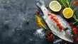 Raw fish with spices herbs and lemon on a background with space for text