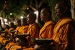 © Elena - monks wearing orange clothes chanting on Vesak day