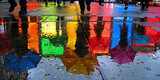 Fototapeta Kosmos - A colorful reflection of umbrellas on a wet street