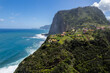Madeira coast, green lush hills and Atlantic Ocean. Aerial drone view