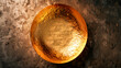 Golden metal empty plate on a stone background. Top view.