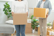 People relocation move home concept, Man carrying belongings box moving in new apartment.