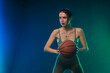 Basketball player. Portrait of woman with a basketball ball in studio. Sports betting concept. Game day.