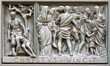 MILAN, ITALY - SEPTEMBER 16, 2024: The relief of Martyrdom of St. Protasius on the bronze gate of Cathedral - Duomo by Arrigo Minerbi (1937 - 1948)