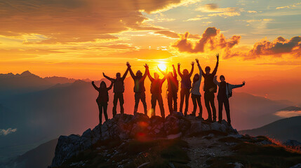 A picturesque shot of a team silhouetted against the setting sun at the summit, celebrating their collective success