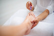 Foot, hands and nail polish for pedicure closeup at spa, treatment for skin and dermatology with makeup. Beauty, wellness and people with cosmetics product for color, self care and cosmetology