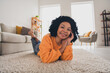 Photo portrait of lovely young lady lying floor have rest weekend dressed casual orange clothes cozy day light home interior living room