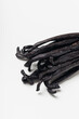 Butch of vanilla beans on light background