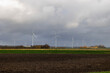 Wind turbines near the Dutch village of Dalmeer under a cloudy sky