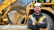 © MOTOKO Stock - Construction Equipment Operator Stands In Front Of A Construction Vehicle And Smiles At The Camera, Perfect For Construction Industry Advertising