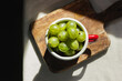 Gooseberry in a red enamel mug and natural sunlight