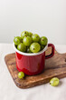 Gooseberry in a red enamel mug