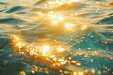 Fototapeta  - sparkling ocean waves with golden sunlight reflections serene water surface