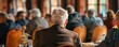 © Milan - An elder lady with grey curly hair faces a blurred audience, possibly during a seminar or a public event, highlighting themes of learning and participation.