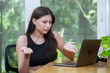 Young asian woman working expressing surprise and dissatisfaction with laptop. female smiling work at home chatting social network meeting online. reading email or shopping online.
