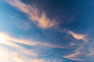 Wall Mural - colorful clouds are in deep blue evening sky, natural background
