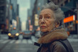 An older woman walks down the street in New York City,