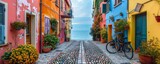 Fototapeta Uliczki - Narrow street of the village of fishermen with colorful houses and a bicycle in early morning