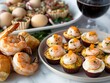 A plate of shrimp and a plate of shrimp cupcakes. The shrimp is served with a side of bread