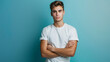 © ksu - Young man in a white T-shirt on a plain blue background