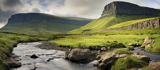 Wall Mural - Stream flowing through distant mountain landscape