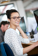 Sticker - Portrait, creative and happy business woman in office at startup company on computer for coworking. Face, professional entrepreneur and smile of employee, worker or web developer in glasses at job