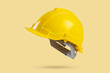 Safety construction helmet on yellow background
