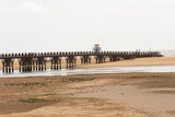 Fototapeta  - Paisaje de la playa de Isla Cristina con su puente de madera.