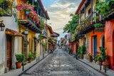 Fototapeta Fototapeta uliczki - A narrow cobblestone street lined with colorful buildings and potted plants