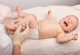 Fototapeta  - Uncomfortable Baby Crying During Routine Vaccination