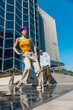 Vertical Screen: Young And Stylish Female Hip Hop Dancer Freestyling On Street In the Circle Of Fashionable Friends. Group Of Young People Supporting Energetic Performer While She Is Practicing