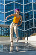 Vertical Screen: Young And Stylish Female Hip Hop Dancer Freestyling On City Street. Professional Street Performer Doing Improvisation In Urban Environment. Caucasian Woman Practicing Choreography.
