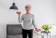 Elderly Sweet Woman Exercises With Dumbbells, Embracing Active Lifestyle And Home Workouts