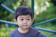 Little asian boy looking in the garden