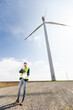 Confident Engineer Overseeing Renewable Energy Project at Wind Farm