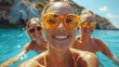 © Fxquadro - A group of friends pose for a fun selfie in the sea with rocky cliffs in the background, reflecting happiness, friendship, and holiday enjoyment