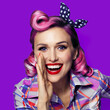 Beautiful happy excited woman holding hand near open mouth. Girl dressed in pin up style wear. Beauty model at retro fashion vintage concept, Isolated against bright color background. Square
