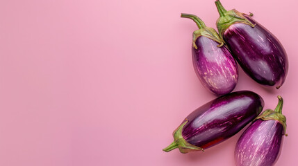 Eggplants on pink background