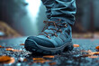 Close up of foot wear outdoor shoes, walking and standing on the wet asphalt.