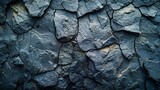 Fototapeta  -   A tight shot of a complex rock wall, composed of diverse types of stones