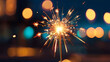 Human hand holding burning sparkler. Bengal fire with bokeh city light background. happy new year and marry Christmas card